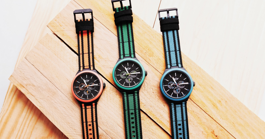 Mini Cooper Ocean Upcycle Collection featuring best lightweight watches with colorful straps on wooden background